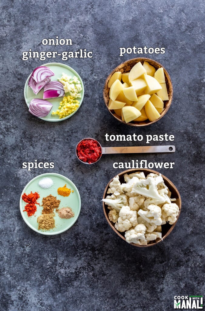 ingredients for aloo gobi arranged on a board