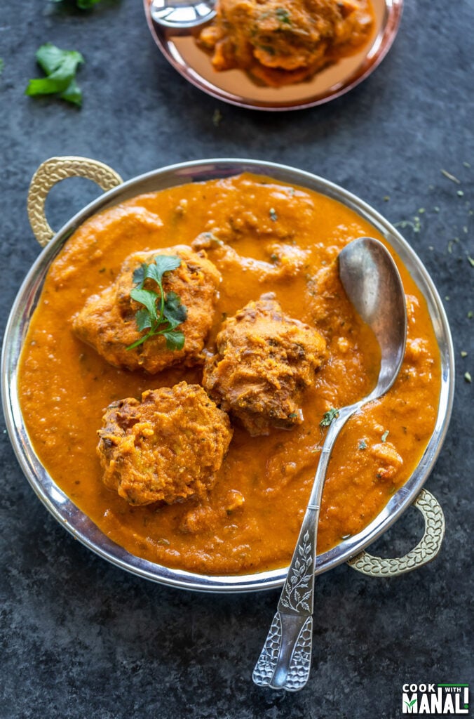 3 koftas arranged in a copper dish topped with cilantro