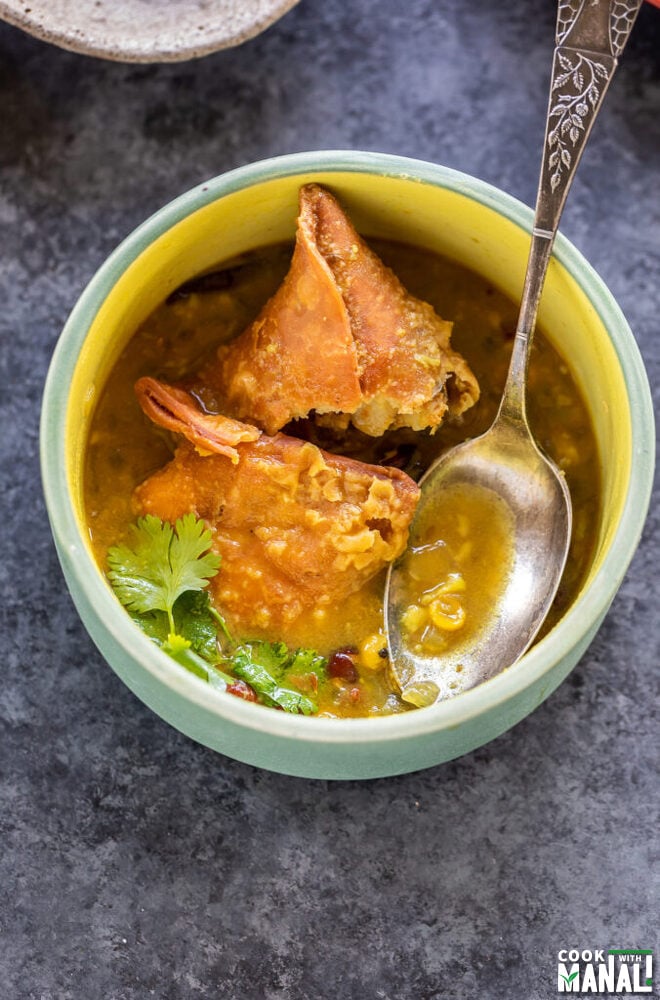 samosa in a bowl, broken into two