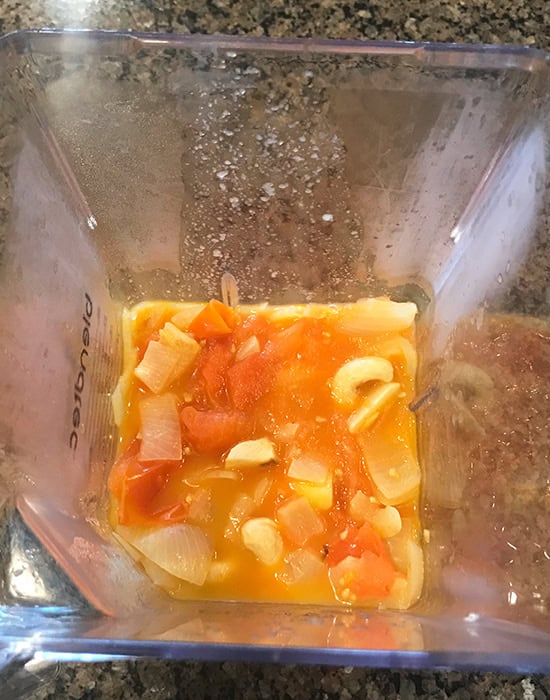 cooked onions and tomatoes in a blender