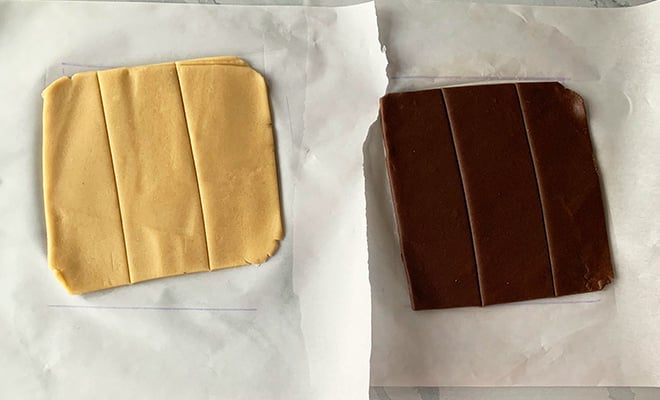 rolled vanilla and chocolate cookie dough cut into three equal parts