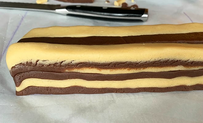 stack of alternating chocolate and vanilla cookie dough for checkerboard cookies