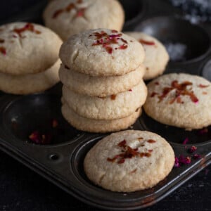stack of cookies on a tray with more cookies on the side