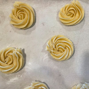 piped cookies on a parchment paper