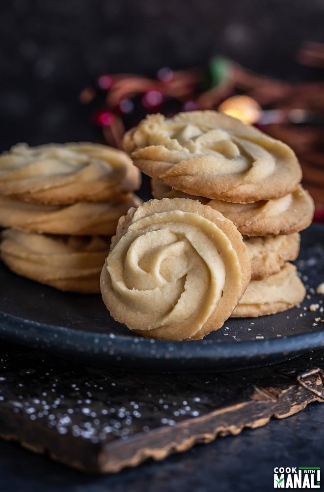 stack of cookies with one rosette shaped cookie placed in the front to show the design