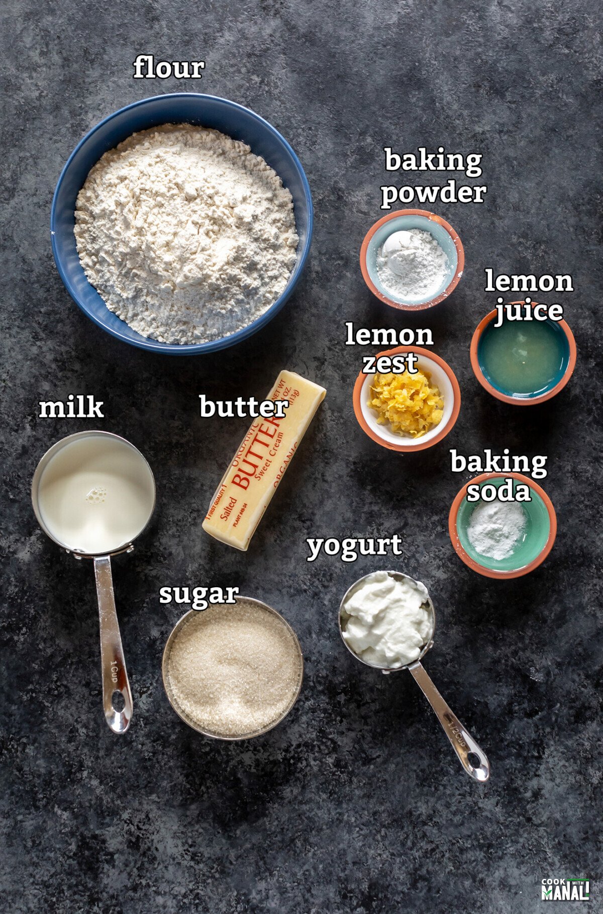 ingredients to make a lemon cake arranged on a board
