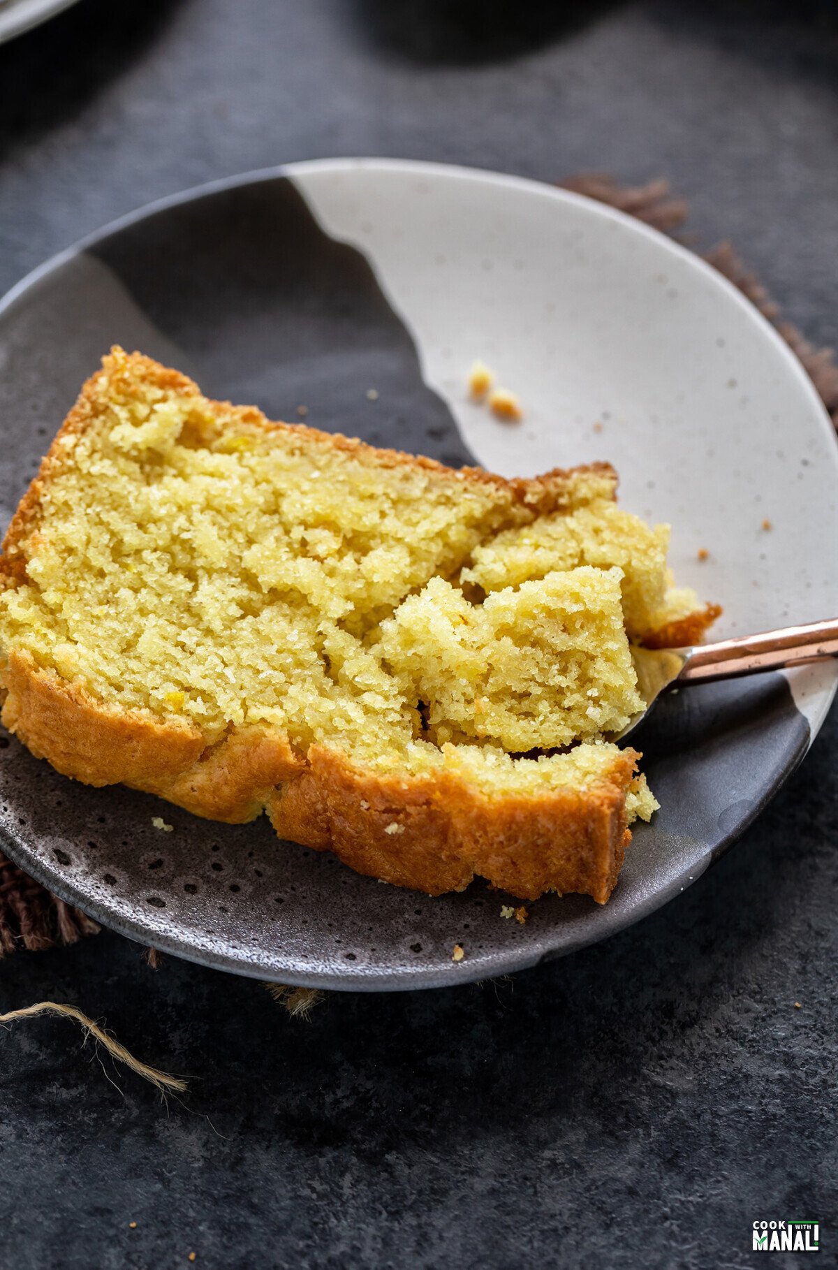 slice of lemon cake cut with a spoon to show the texture of the cake
