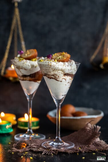 gulab jamun fusion dessert arranged in martini glasses with diyas in the background