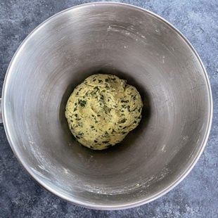 dough with fenugreek leaves placed in a steel bowl