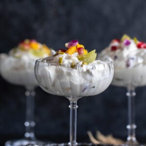 3 glasses filled with whipped cream and fruits