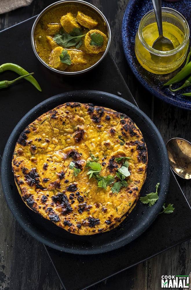 overhead shot of missi roti in a round black plate