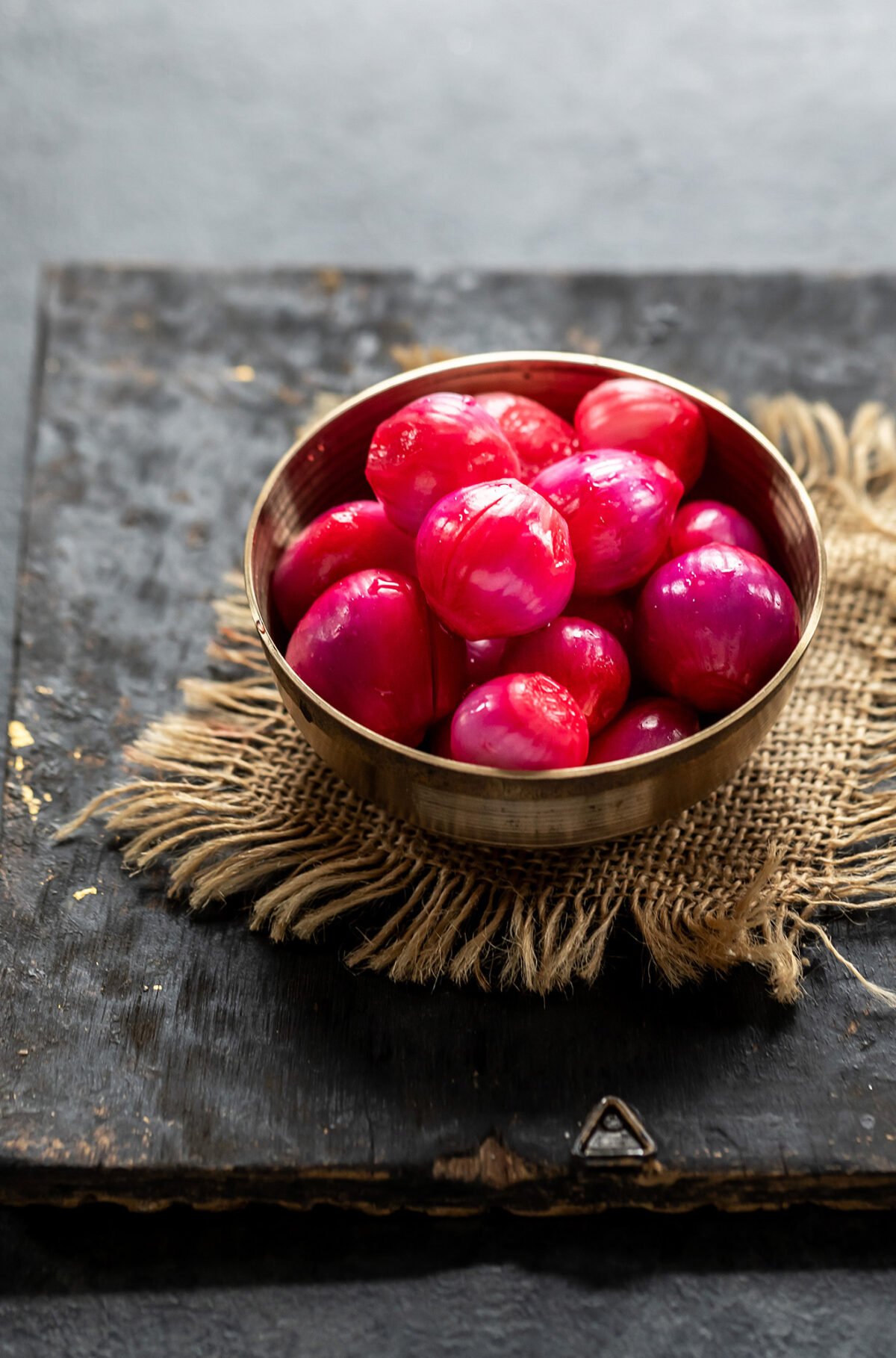 pickled pearl onions served in a bronze bowl