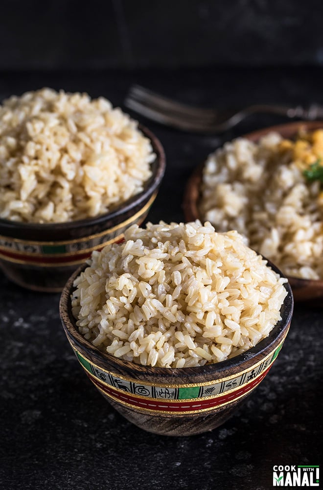 brown rice served in a small wooden bowl