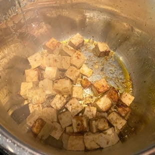 cubes of tofu being fried in instant pot