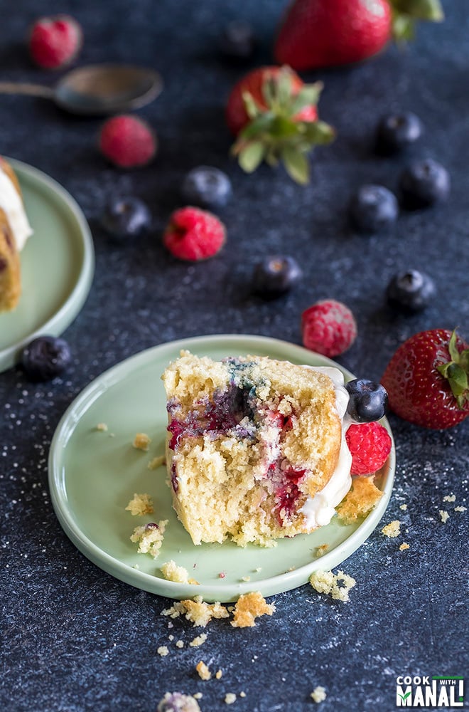 a slice of berry vanilla cake in a small light green plate
