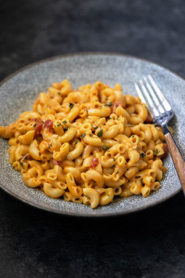 masala mac and cheese in a bowl with fork placed on the side