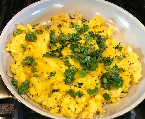 mashed potatoes in a pan sprinkled with cilantro