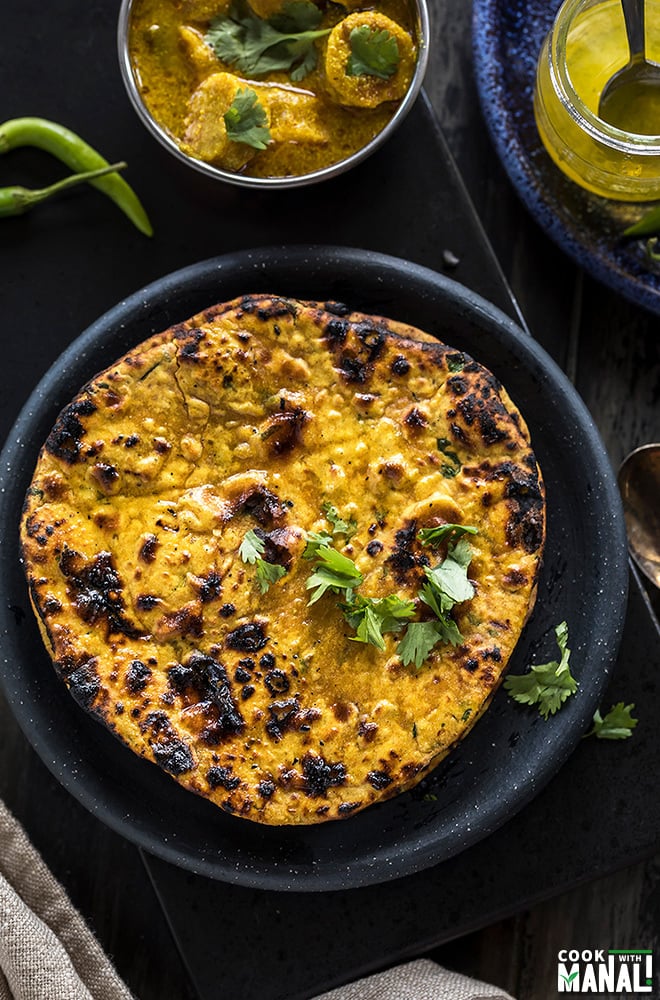 overhead shot of missi roti in a round black plate
