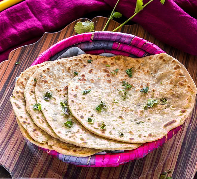 mooli paratha arranged in a pink basket