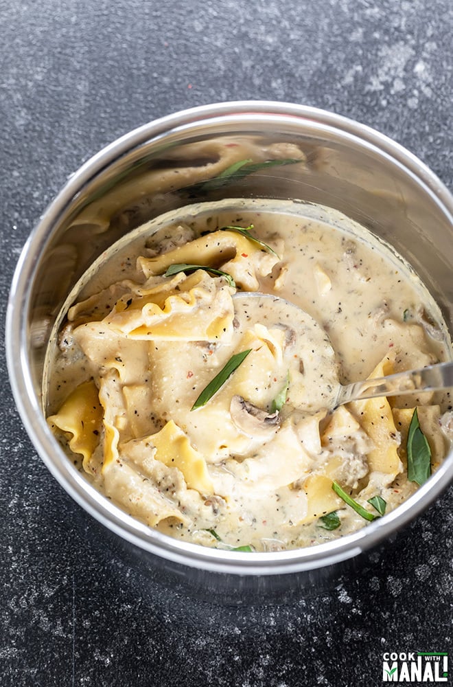 mushroom white lasagna soup in instant pot with a serving ladle