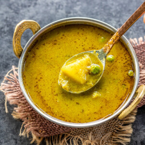 nimona curry served in a copper kadai with a copper spoon
