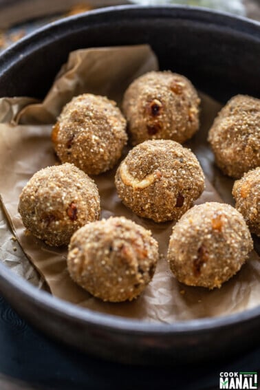 8 round balls made of quinoa placed in a black round pan