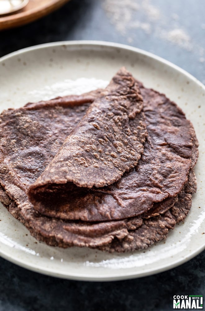 few ragi roti placed on a white plate