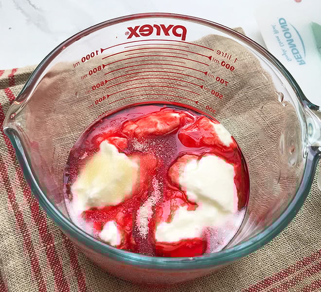 ingredients for rose lassi in a large measuring jar