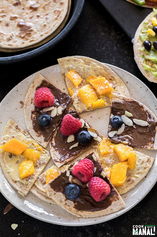 rotis cut into triangles and topped with nutella, mango and berries