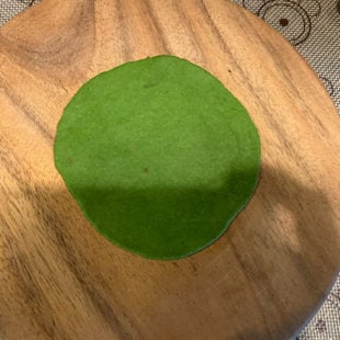 green color dough rolled into a circle
