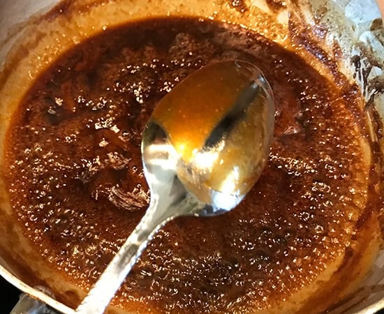 a spoon showing the consistency of a chutney
